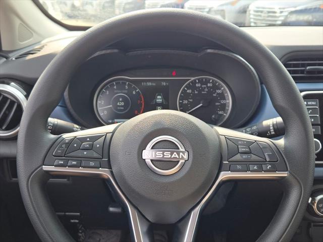 Photo of 2025 Aspen White Tricoat Nissan Versa