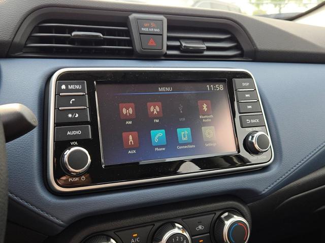 Photo of 2025 Aspen White Tricoat Nissan Versa