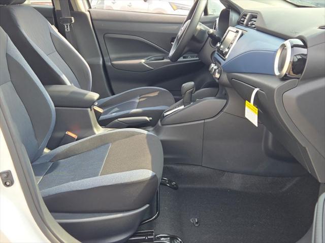 Photo of 2025 Aspen White Tricoat Nissan Versa