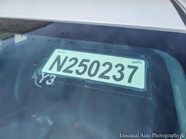 Photo of 2025 Aspen White Tricoat Nissan Versa