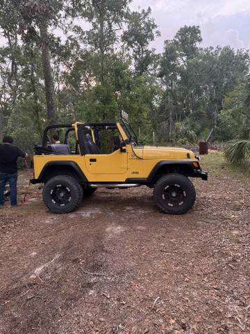 Photo of 2002 Yellow Jeep Wrangler